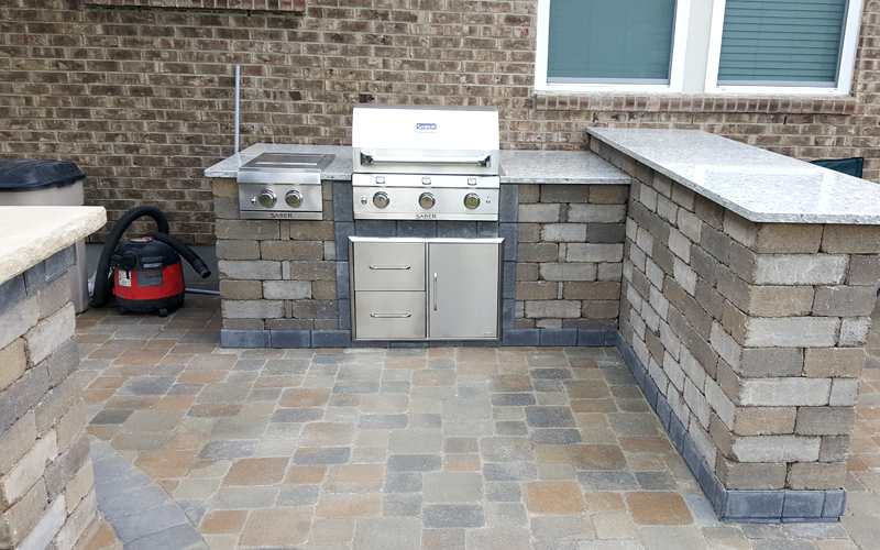 A beautiful outdoor kitchen with grill ready to use in the summer and fall months.