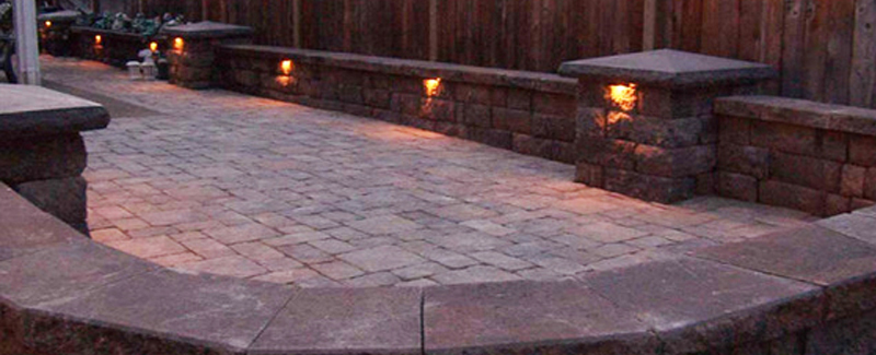 Outdoor lighting on a back yard at dusk.